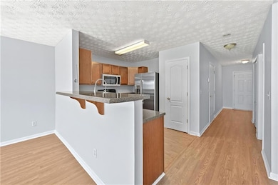 Kitchen featuring a breakfast bar, a peninsula, li