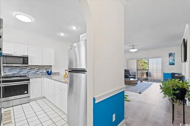 Kitchen with arched walkways, white cabinets, deco