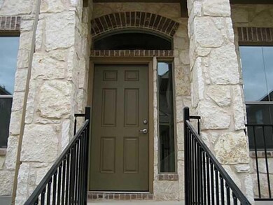 View of exterior entry featuring stone siding