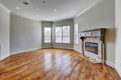 LIVING ROOM - Expansive and inviting living room radiates warmth and hospitality. Beautiful hardwood flooring and many windows for an abundance of natural light.