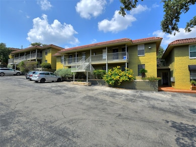 View of property featuring uncovered parking