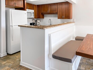 Kitchen featuring backsplash, kitchen peninsula, t