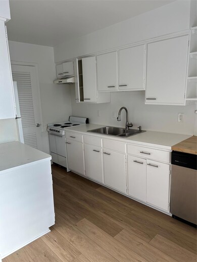Kitchen featuring range hood, light wood finished