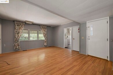 Unfurnished living room with wood finished floors and wood walls