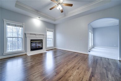 Sitting room/ family room with hardwood floors, gas fireplace and tons of natural light