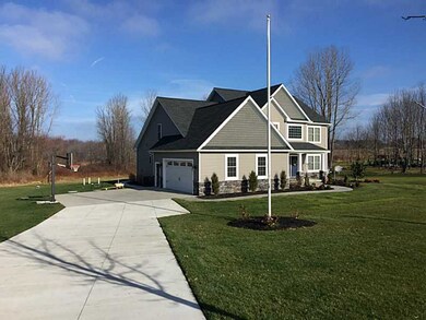 Exterior Front. Flag pole, driveway is concrete, a