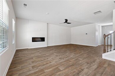Unfurnished living room featuring stairs, visible 