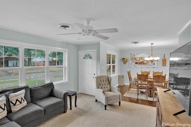 living room opens to dining and kitchen