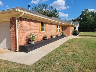 View of home's exterior featuring a garage and a l