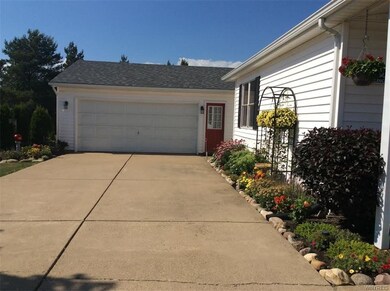 double-wide, concrete driveway with 2.5 car garage