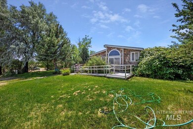 View of green lawn featuring a deck
