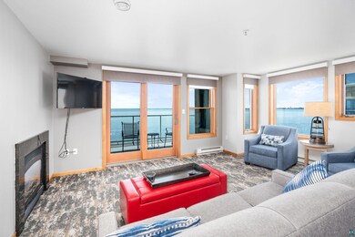 Carpeted living room with baseboard heating and a 