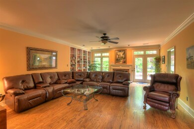 Large inviting living room boasts built-in bookshe