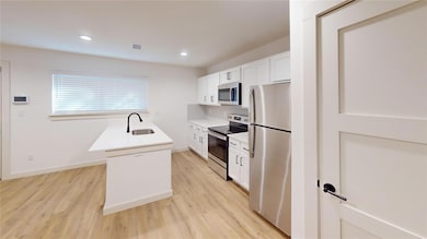 Kitchen with visible vents, light wood finished fl