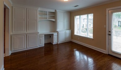 Spacious living room with wood floors and built in