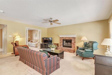 Family room has wood burning fireplace and ceiling