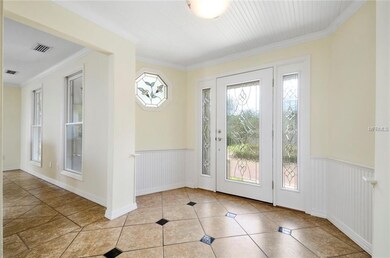 Bright entry with leaded glass door and beadboard 