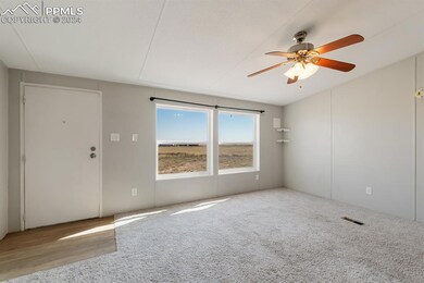 Empty room featuring ceiling fan and light hardwoo