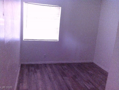 Spare room with wood finished floors and baseboards