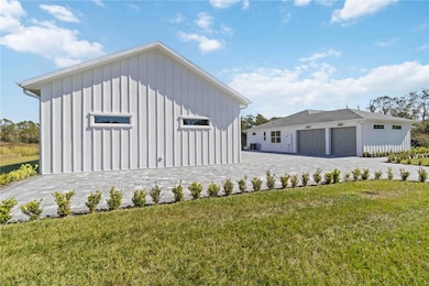 Front face of the guest house looking at the main house's (2x) 12'x8' and 8'x8' custom wood paneled garage doors. The additional parking next to the guest house is designed for guests or you 50' motor coach. Note, on the side of the guest house you'll find a 50amp receptacle to power your large RV, the ability to connect to the oversized septic system designed specifically for a 50ft RV capacity, as well as, multiple outlets and hose bibs to ensure you are not without power or water for any of your toys.