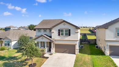 Traditional-style home featuring stucco siding, a garage, concrete driveway, and a shingled roof