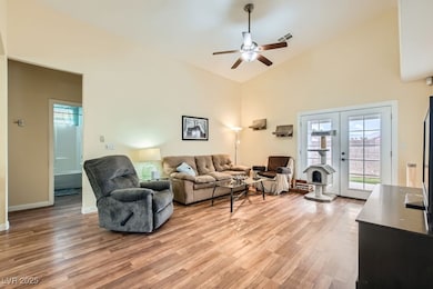 Living room with french doors, ceiling fan, high v
