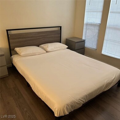 Bedroom with dark wood-type flooring