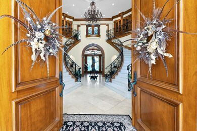 Featuring stunning double wooden arched entry door