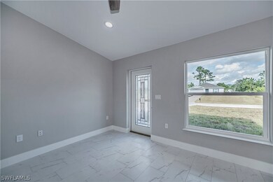 Empty room with lofted ceiling and light tile floo