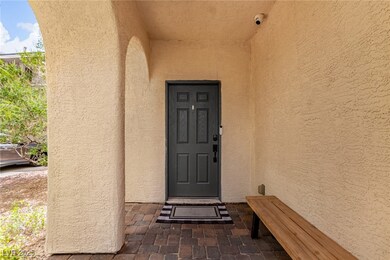 Doorway to property featuring stucco siding