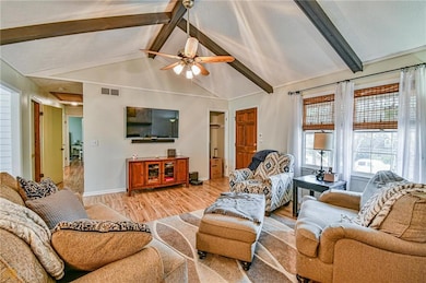 Living area featuring light wood-style floors and ceiling fan