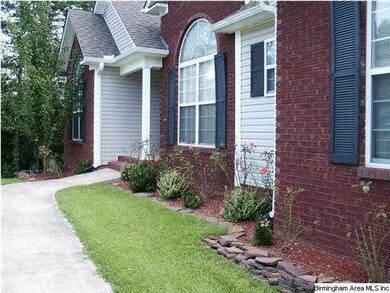 Nicely landscaped walk leads to front door.