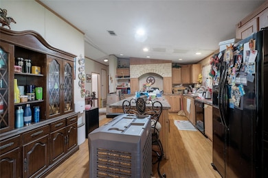 Kitchen featuring black appliances, a center isla