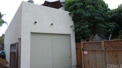 Garage facing street with deck on top.