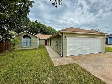 Ranch-style house featuring a front lawn, fence, a
