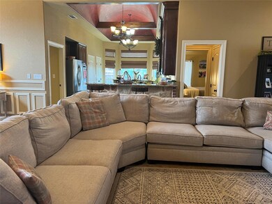 Living room with beamed ceiling and an inviting ch