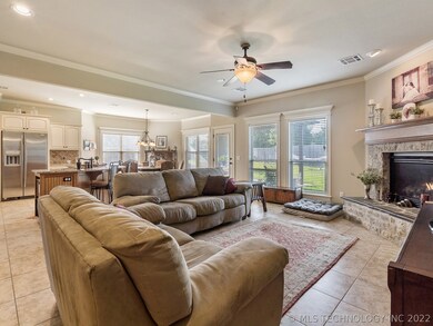 Living area is very well lit, leads to covered bac