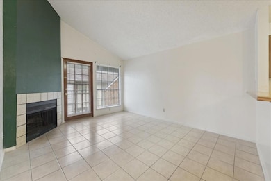 Unfurnished living room featuring a fireplace, lig