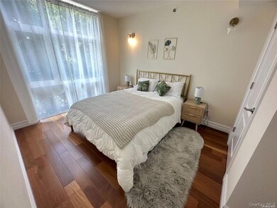 Bedroom featuring baseboards and wood finished floors