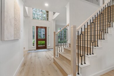 Beautiful entry with designer touches throughout, including modern iron balusters and white oak risers and treads!