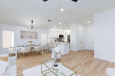 Living area with light wood-style flooring, a chan