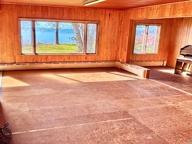 Unfurnished living room with wood walls