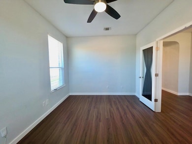 Unfurnished room featuring dark wood finished flo