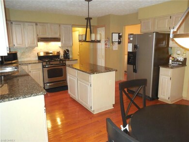 Kitchen-center island & stainless appliances.