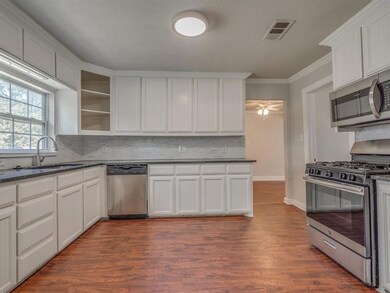 Kitchen with granite and stainless steel.
