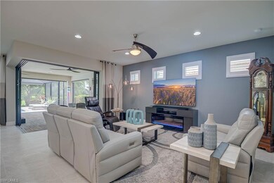 Open living room & dining for entertaining-  with recessed lighting, a ceiling fan, and light tile patterned floors. Zero edge doors make indoor/outdoor flow easy to the lanai area and pool