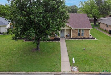 View of front of home featuring a porch, brick sid