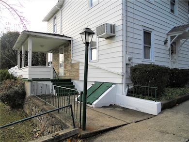 Outside basement entrance and a covered side porch