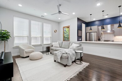 Living room featuring a ceiling fan, dark wood-style floors, and recessed lighting