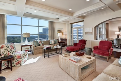 Living area with beam ceiling, arched walkways and expansive views.